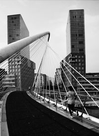 Low angle view of woman standing against sky