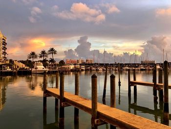 Pier on sea against sky during sunset