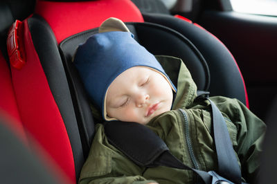 Cute baby boy sleeping in car