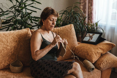 Man sitting on sofa at home
