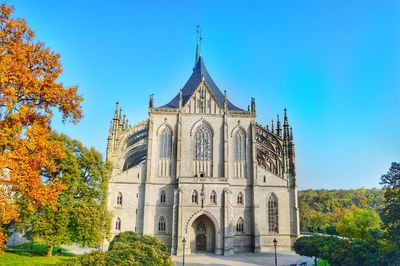 Low angle view of trees and st barbara cathedral against sky