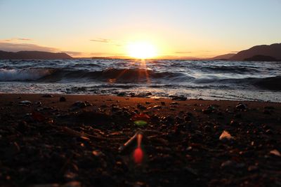 Close-up of sea against sky during sunset