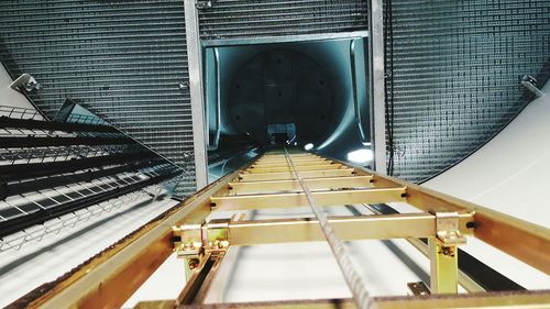 Directly above shot of ladder with rope inside wind turbine