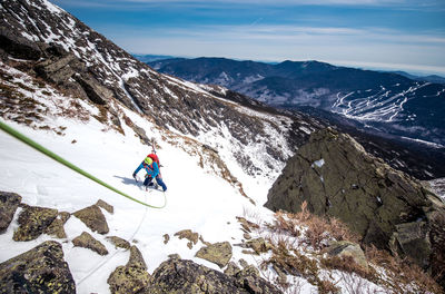 Man riding motorcycle on snowcapped mountains