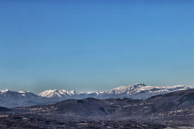 Scenic view of mountains against clear blue sky