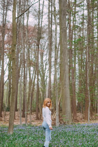 Woman standing in forest