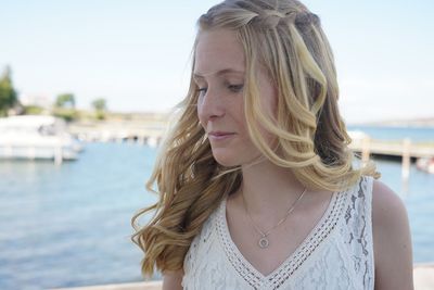 Portrait of beautiful woman against sky