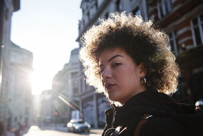 Portrait of beautiful young woman in city