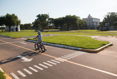 Man riding bicycle on sidewalk in city