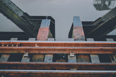 High angle view of rusty metallic bridge over lake