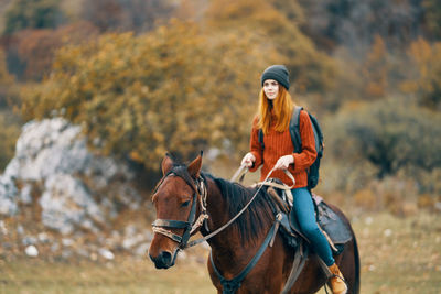 Portrait of young woman riding horse