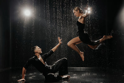 A couple of dancers on a black background in a studio in the aqua zone