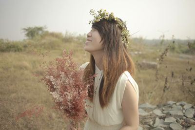 Young woman standing on field