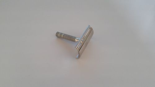 High angle view of metal equipment on table against white background