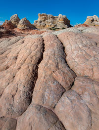 Low angle view of rock formations against sky