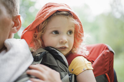 Midsection of father carrying cute daughter in forest