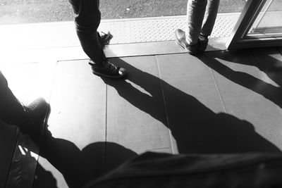 Low section of people standing on tiled floor