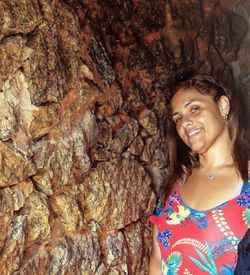 Close-up of young woman with tree trunk