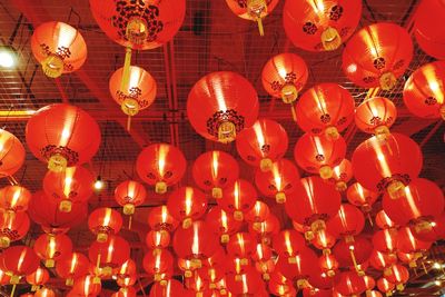 Low angle view of illuminated lanterns hanging on ceiling