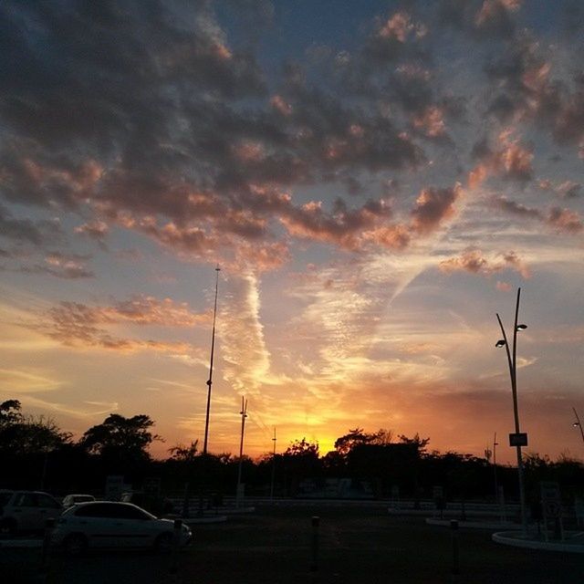 sunset, sky, transportation, cloud - sky, car, mode of transport, land vehicle, street light, orange color, silhouette, cloudy, tree, dramatic sky, scenics, beauty in nature, cloud, road, nature, street, outdoors