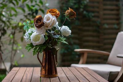 White rose in vase on table