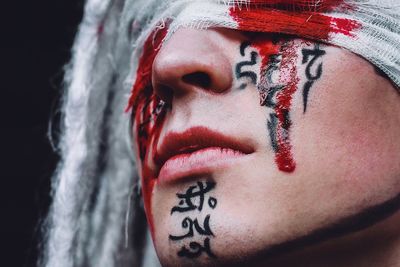 Close-up of woman with blood stained bandage