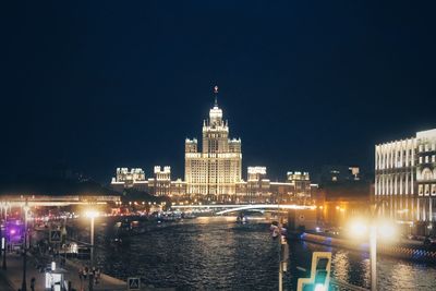 Illuminated city at waterfront