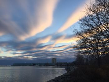 Scenic view of river against cloudy sky