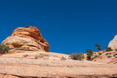 Low angle landscape of orange stone hillsides at checkerboard mesa in zion national park