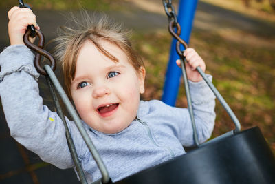 Portrait of happy boy holding camera