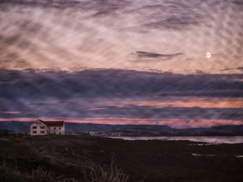 Scenic view of buildings against sky at sunset