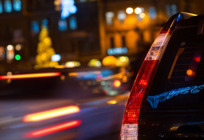 Rear lights of a black car, close-up evening city