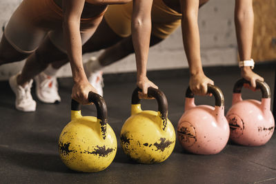 Anonymous female athletes in the exercise of kettlebells effort and self-improvement