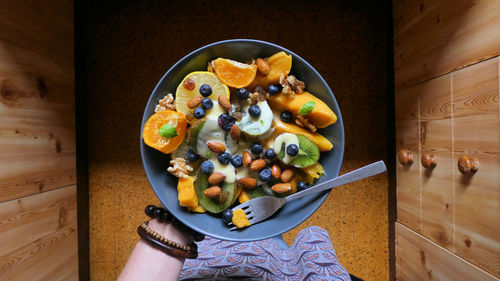 High angle view of person standing holding bowl breakfast 