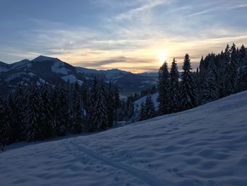 Scenic view of snowcapped mountains against sky during sunset