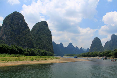 Panoramic view of sea and mountains against sky