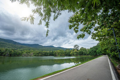 Scenic view of lake by mountains against sky