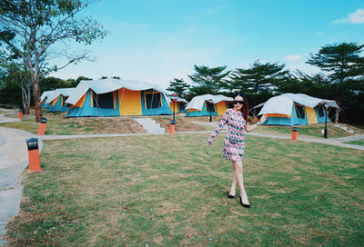 Rear view of woman walking on field