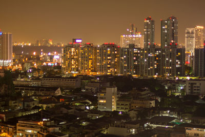 High angle view of illuminated buildings against sky at night