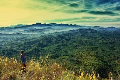 Man looking at landscape against sky