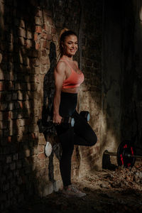 Portrait of woman while standing in abandoned building