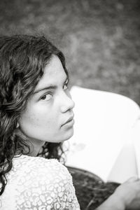 Teenage girl reading book at park