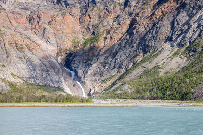 Scenic view of sea against rocky mountains