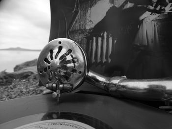 Close-up of wheel by sea