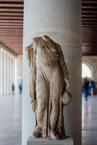 Close-up of statue against historic building