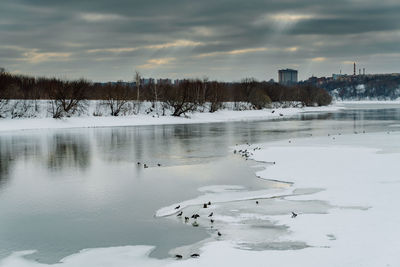 Scenic view of frozen lake against sky during winter