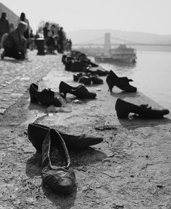 Close-up of shoes on beach