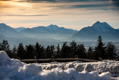 Scenic view of snowcapped mountains against sky during sunset