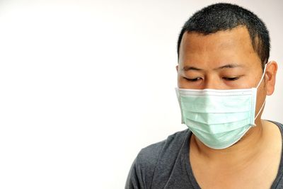 Portrait of young man against white background