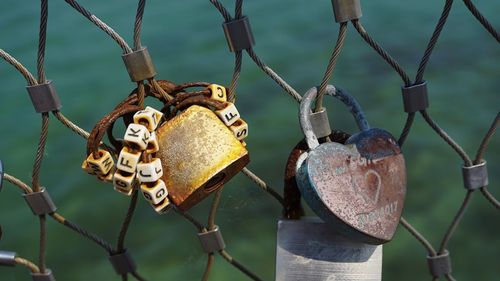 Close-up of padlocks on fence